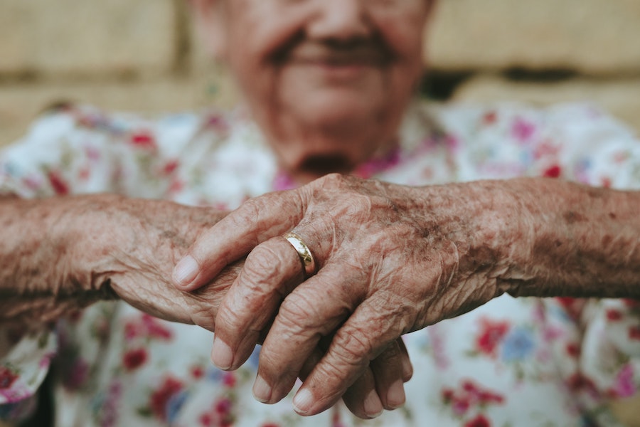 An elderly woman’s hands clasped together