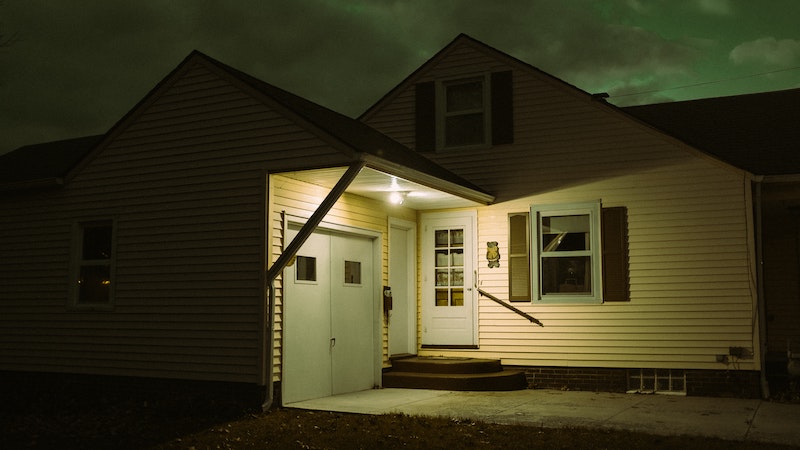 House at night with a bright porch light on.