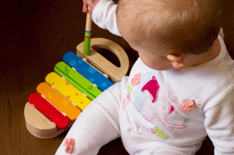 a baby is playing a toy instrument