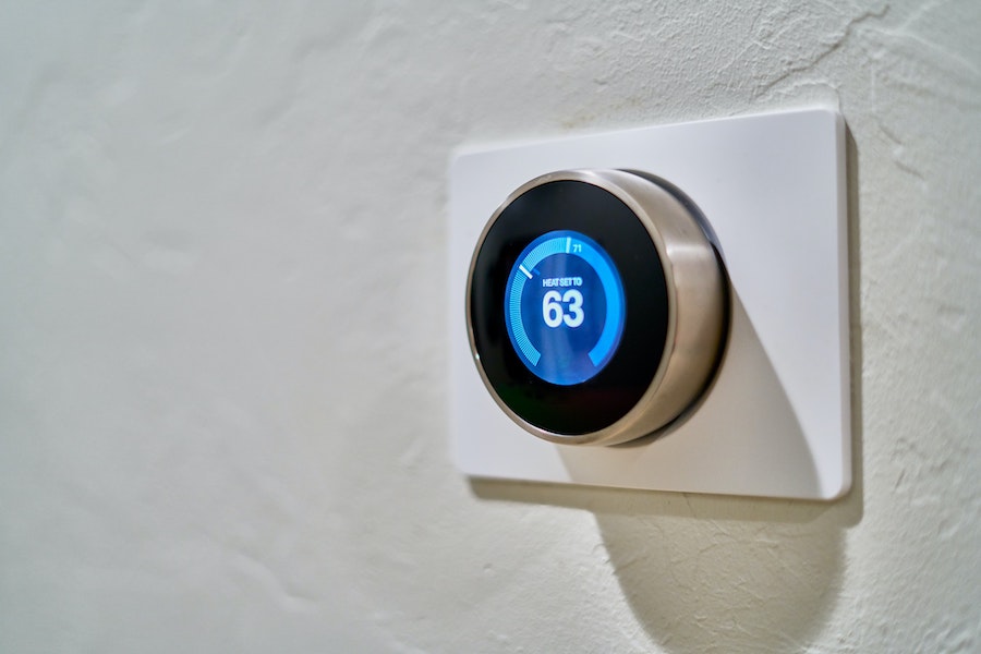 A Nest smart thermostat attached to a wall