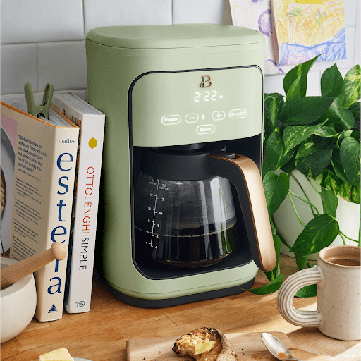 a green coffee machine from Drew Barrymore's brand Beautiful