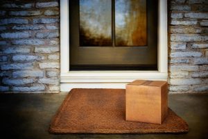 a package is placed on a porch of a house