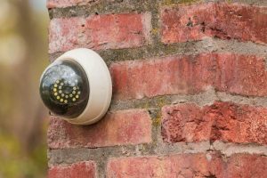 A fake security camera attached to a brick wall