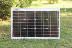 A small solar panel placed on grass