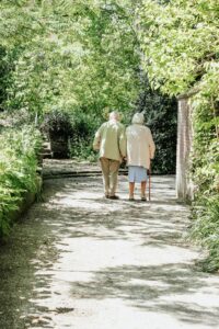 elderly people walking in a garden