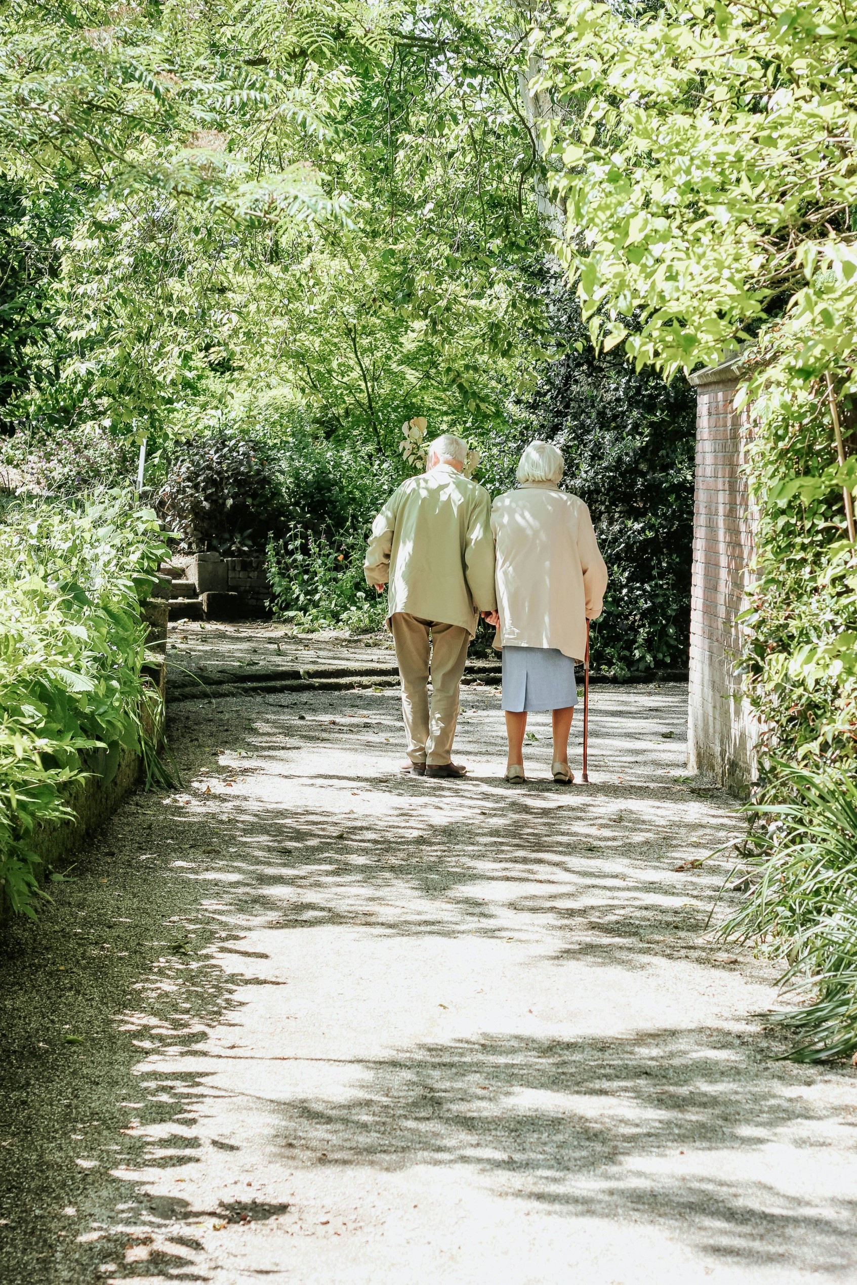 elderly people walking in a garden
