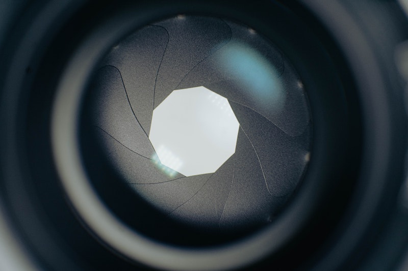 Aperture is the opening that allows light to enter the lens. It can be made wider or narrower.