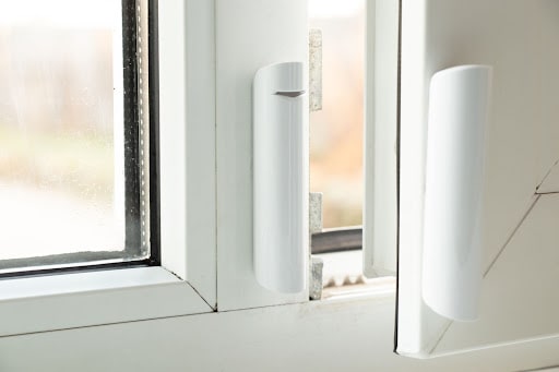 A window alarm sensor connected to a window.