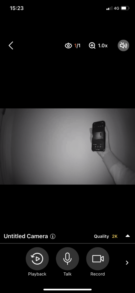 AlfredCam Plus captured footage (a hand holding a smartphone) via night vision.