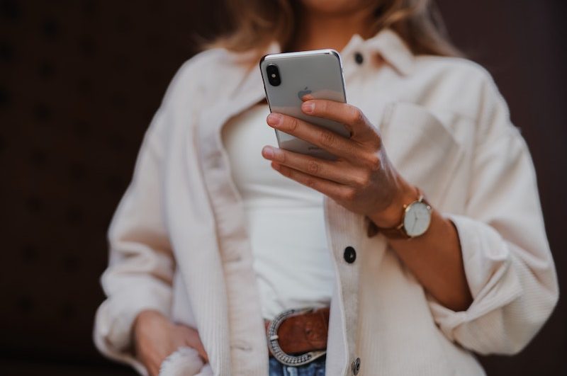 Woman holding a white smartphone